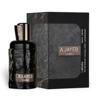 Perfume bottle and packaging with 'AJAYEB DUBAI' branding on a white background