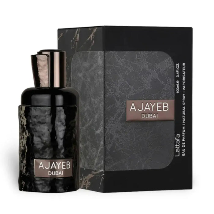 Perfume bottle and packaging with 'AJAYEB DUBAI' branding on a white background