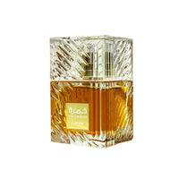Decorative glass perfume bottle with intricate design on a white background
