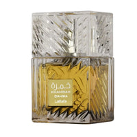 Perfume bottle with intricate design and gold label on a white background