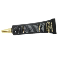 Black cosmetic tube with gold accents on a white background