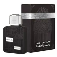 Black perfume bottle and packaging with 'RAMZ LATTafa' branding on a white background