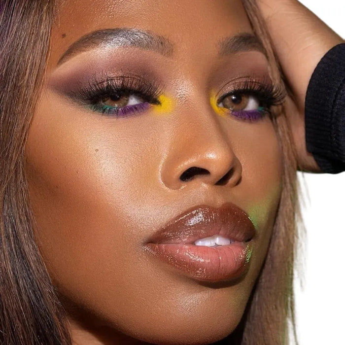 Close-up of a person with colorful makeup on a white background