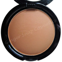 Compact powder in a black case with 'Ginger Snap Cosmetics' branding.
