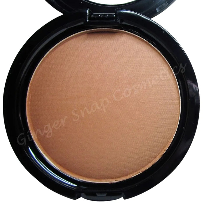 Compact powder in a black case with 'Ginger Snap Cosmetics' branding.